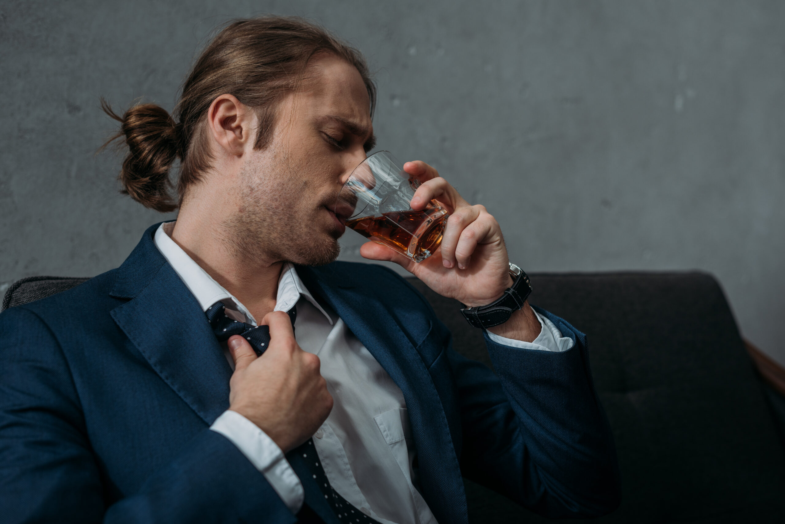 young alcohol addiction businessman drinking whiskey