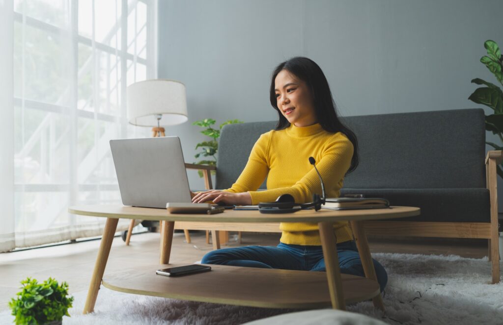 Attractive young Asian woman smiling happily at home studying internet video communication online us