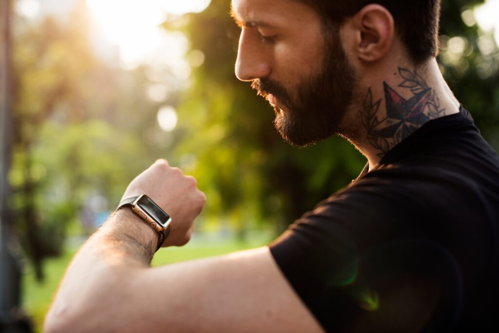 A man looking at his smartwatch