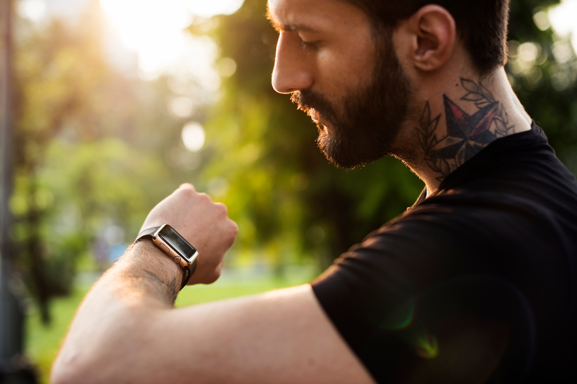 A man looking at his smartwatch