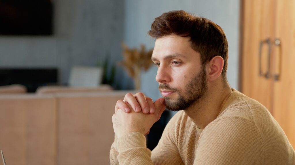 Handsome man thinking about idea close-up