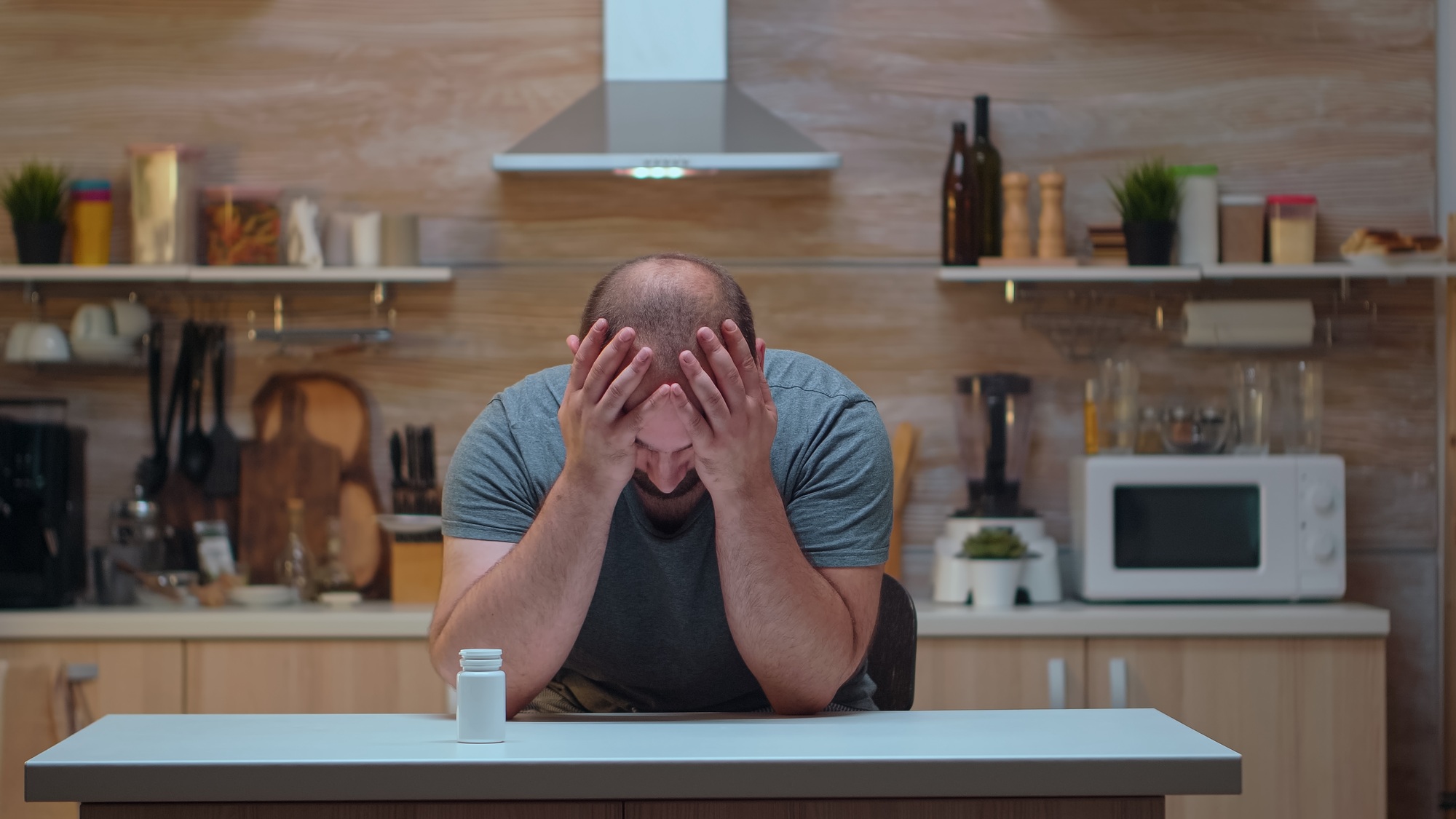 Husband with headache taking pills