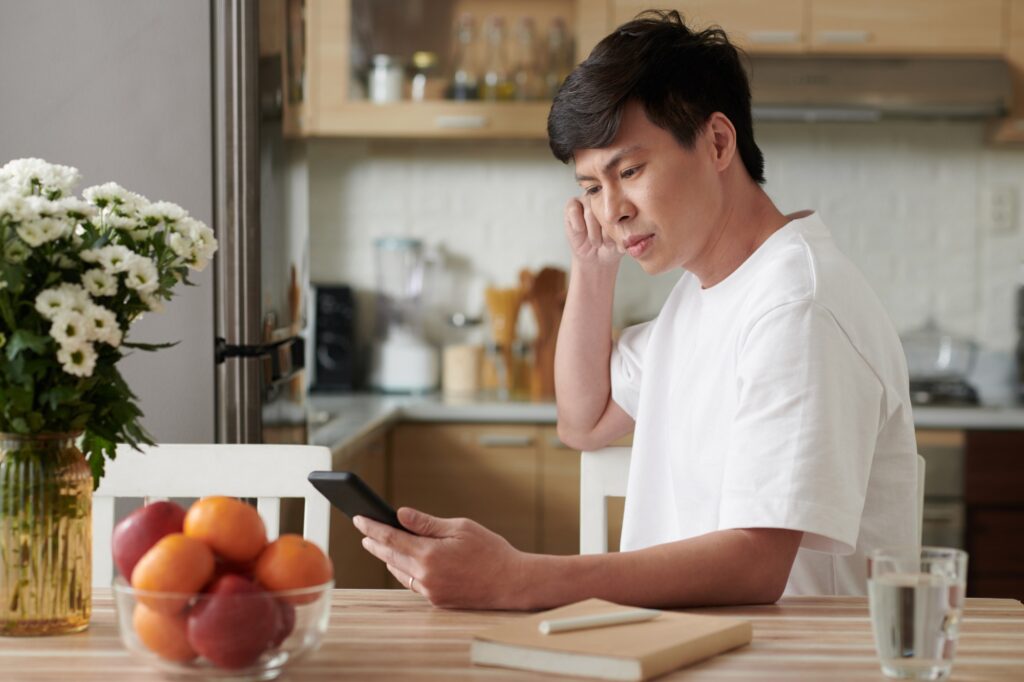 Man Reading Article on Smartphone