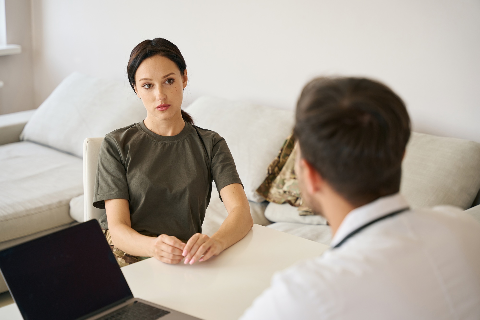 Military woman talking to doctor in hospital