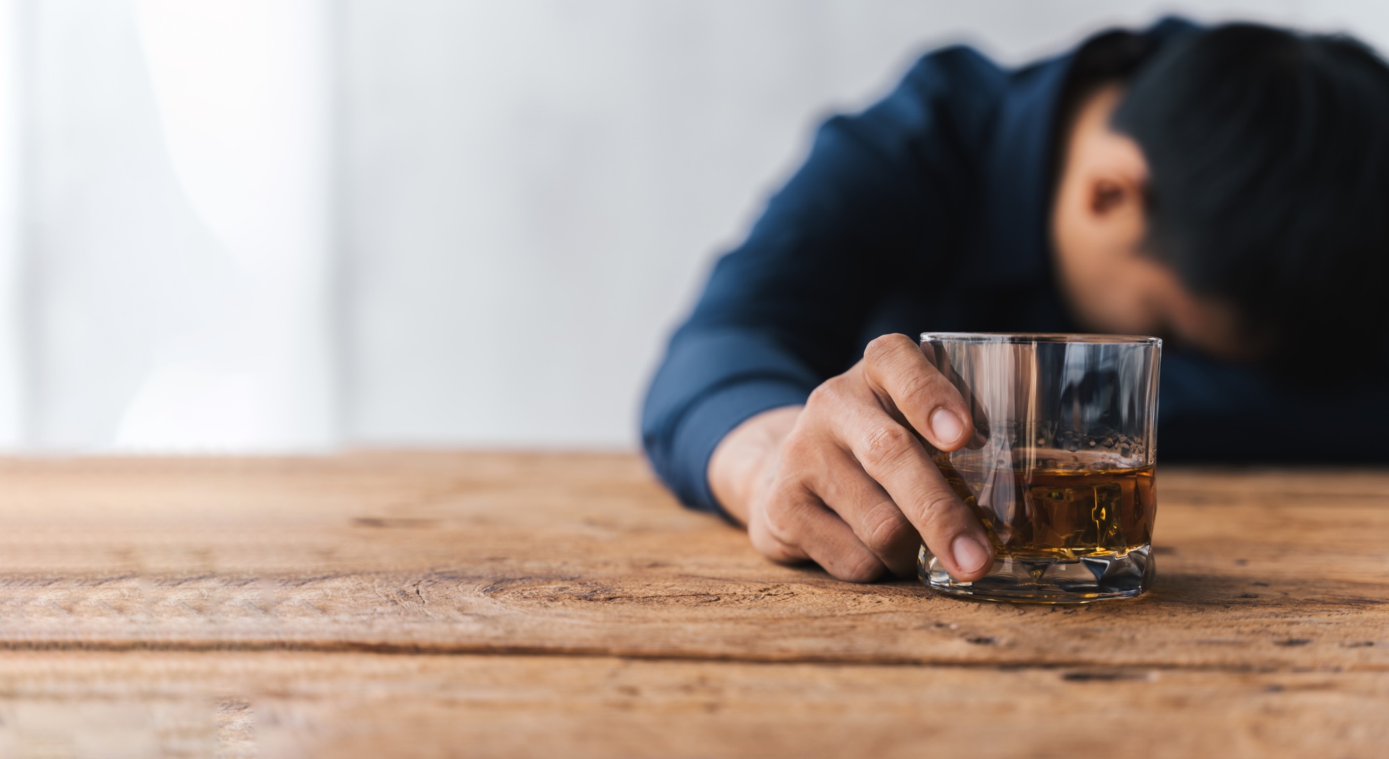 drunk asian man hold whisky glass addicted alcohol need therapy.