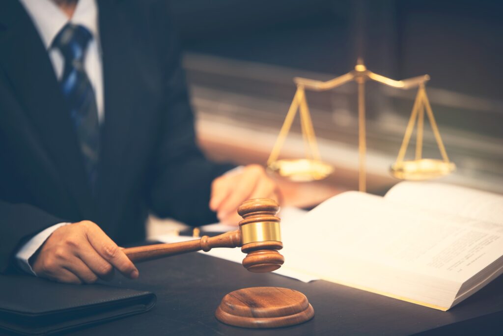 lawyer holding judge gavel in courtroom